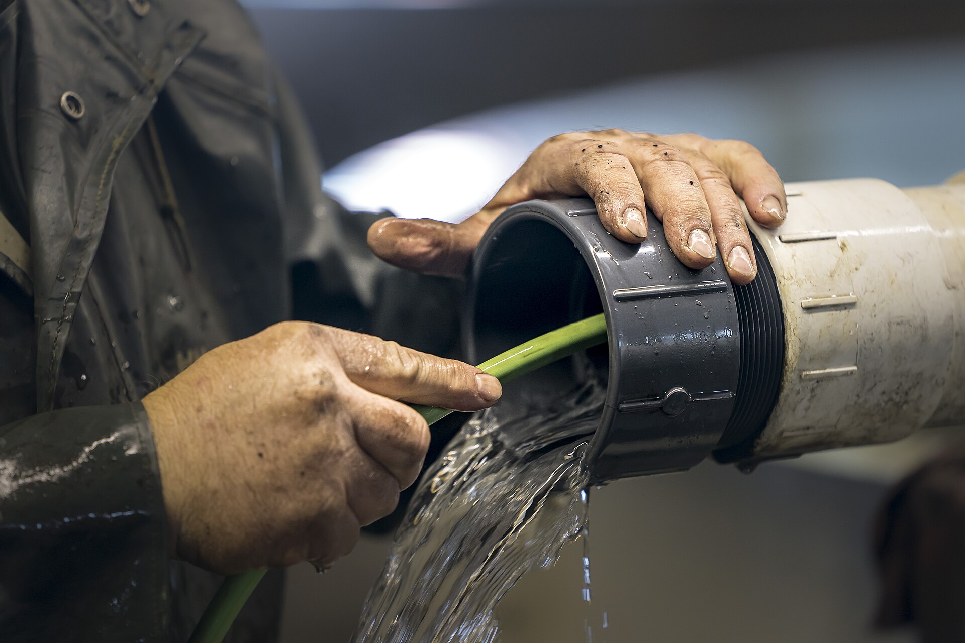 Plumbing technician maintaining a commercial pipe system
